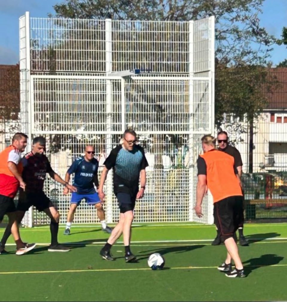 Men playing walking football on the Tile Hill MUGA pitch